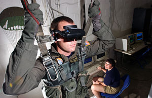 U.S. Navy personnel using a VR parachute trainer