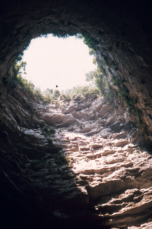 A caver rappelling the 333-meter drop into Sot...